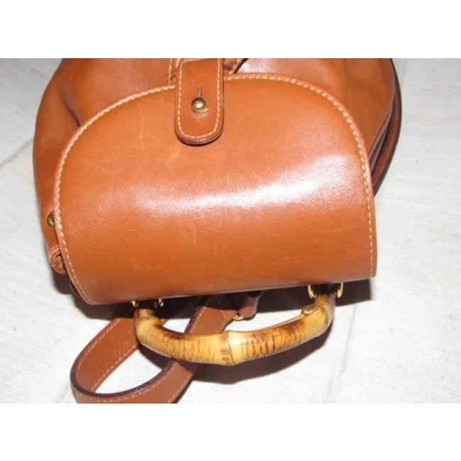 Gucci caramel brown colored leather, two strap, petite, drawstring top, multi-pocket, messenger bag/backpackk