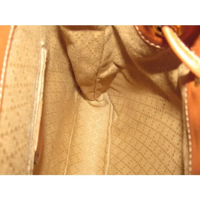 Gucci caramel brown colored leather, two strap, petite, drawstring top, multi-pocket, messenger bag/backpackk