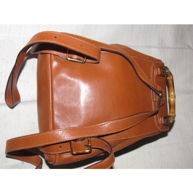 Gucci caramel brown colored leather, two strap, petite, drawstring top, multi-pocket, messenger bag/backpackk