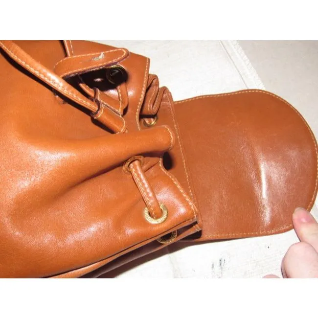 Gucci caramel brown colored leather, two strap, petite, drawstring top, multi-pocket, messenger bag/backpackk