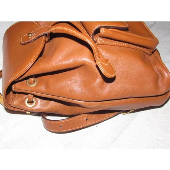 Gucci caramel brown colored leather, two strap, petite, drawstring top, multi-pocket, messenger bag/backpackk