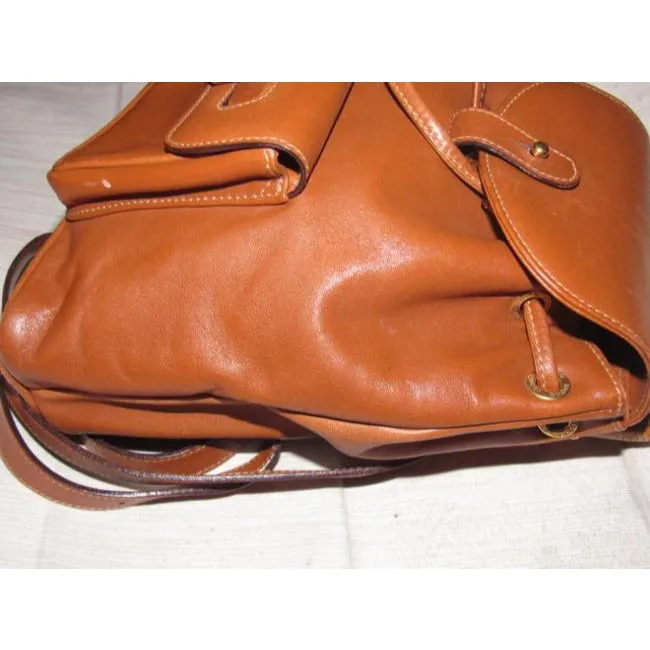 Gucci caramel brown colored leather, two strap, petite, drawstring top, multi-pocket, messenger bag/backpackk