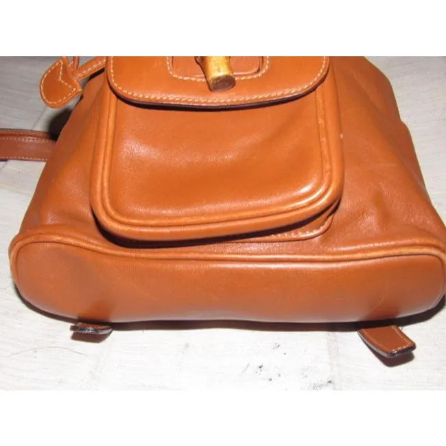 Gucci caramel brown colored leather, two strap, petite, drawstring top, multi-pocket, messenger bag/backpackk