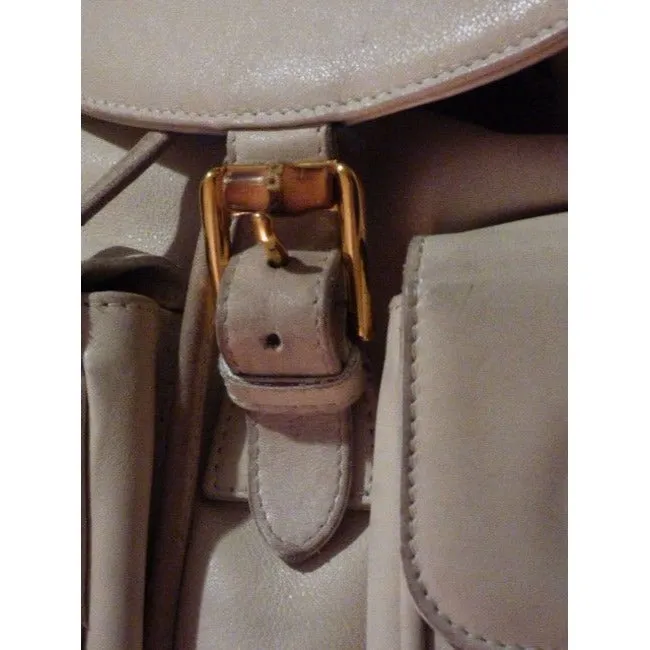 Gucci, white leather, larger size, two strap and bamboo handle, drawstring top, multi-pocket, messenger bag/backpack
